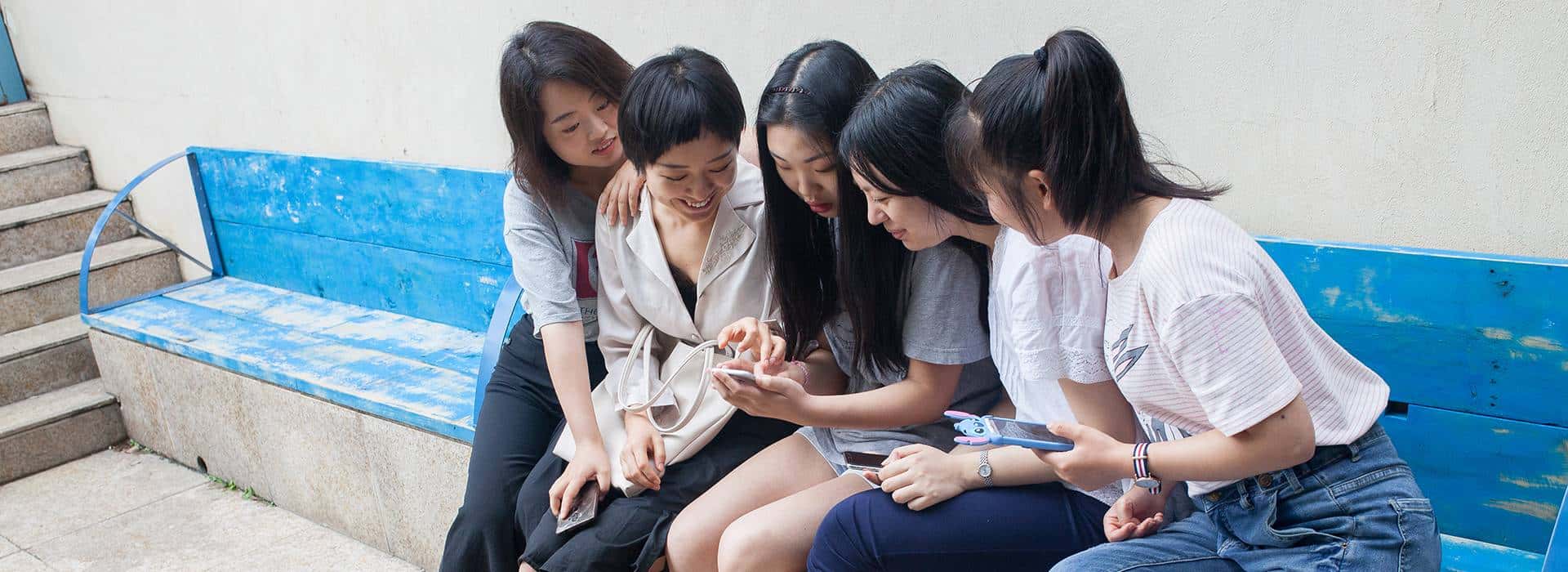 Five young Chinese women using social media